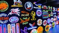 Neon signs light up the manufacturers' midway during opening day of the Charlotte AutoFair at Charlotte Motor Speedway.