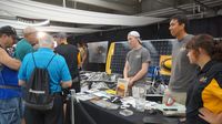 Students from Appalachian State University take to visitors about their custom-designed and built solar-powered vehicle during Day 2 of the Charlotte AutoFair at Charlotte Motor Speedway.