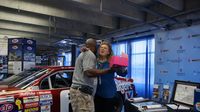 Vendors greet visitors in the manufacturers' midway during Day 2 of the Charlotte AutoFair at Charlotte Motor Speedway.