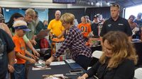 "Dukes of Hazzard" actress Catherine Bach signs autographs for fans during Saturday's fun at the Charlotte AutoFair at Charlotte Motor Speedway.