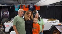 Catherine Bach, who played Daisy Duke in the TV hit series "Dukes of Hazzard" poses for photos alongside her classic Jeep Golden Eagle during Saturday's fun at the Charlotte AutoFair at Charlotte Motor Speedway.