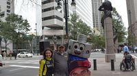 A fan poses for a photo with Lug Nut and Miss Sprint Cup during a Laps Around Uptown event in Center City Charlotte Monday to kick off race week at Charlotte Motor Speedway.
