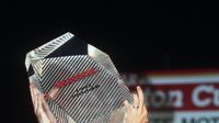 Jeff Gordon raises The Winston's winner's trophy over his head in celebration after his 1997 win at Charlotte Motor Speedway.