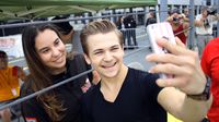 Hunter Hayes takes a selfie with a lucky fans while at Charlotte Motor Speedway for a Rusty Wallace Racing Experience ride along. Hayes was at the speedway to promote his pre-race concert before the Bank of America 500 on Saturday, Oct. 10, 2015.