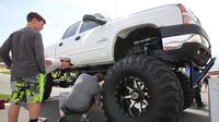 A "jacked up" pickup draws the eye of fans at the Pennzoil AutoFair presented by Advanced Auto Parts at Charlotte Motor Speedway.