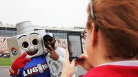 Lug Nut, the world's fastest mascot, poses for photos with fans at the Pennzoil AutoFair presented by Advanced Auto Parts at Charlotte Motor Speedway.