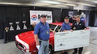 Members of the East Coast Cruisers car club present a check to Speedway Children's Charities during the Best of Show awards ceremony Sunday at AutoFair.