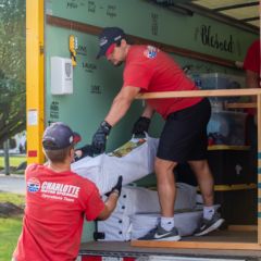 Crews upfit a box truck with special shelving for Ester's Heart, one of four nonprofits Charlotte Motor Speedway served as part of its fifth annual Day of Service.
