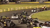 Cars round Turn 4 to take the green flag during opening night of the Bojangles' Summer Shootout at Charlotte Motor Speedway.