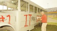 The Independent Tribune's Mark Plemmons paints his bus before the Media Mayhem School Bus Slobberknocker during Round 4 action at the Bojangles' Summer Shootout.