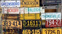 A collection of vintage license plates hangs on display during opening day at the Charlotte AutoFair.