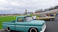 Visitors look over a restored custom truck on display along the frontstretch during opening day at the Charlotte AutoFair.