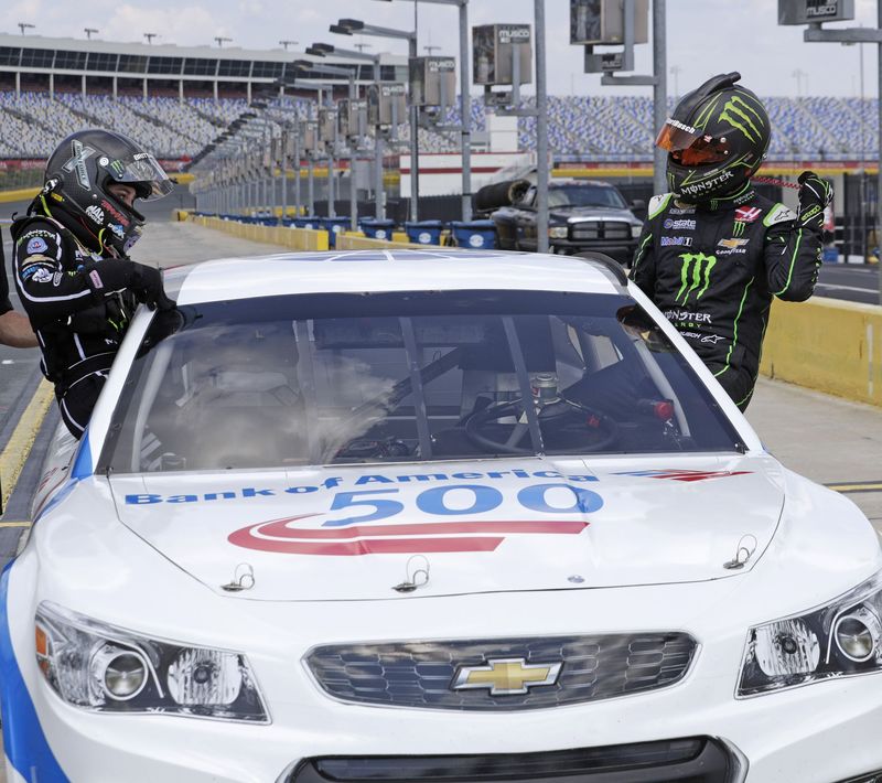NHRA star Brittany Force, left, climbs out of a Richard Petty Driving Experience car after a ride from NASCAR driver Kurt Busch, right, Wednesday at Charlotte Motor Speedway.