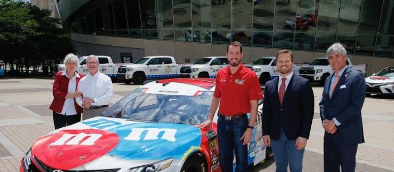 (From left) Dona and Gene Griffin, the parents of fallen U.S. Army Sgt. Dale Griffin, join defending Coca-Cola 600 winner Kyle Busch, Speedway Motorsports, Inc. President and CEO Marcus Smith and Charlotte Motor Speedway Executive Vice President and General Manager Greg Walter in unveiling Busch's patriotic paint scheme for the 60th Coca-Cola 600 in a special event on Wednesday at the NASCAR Hall of Fame. 